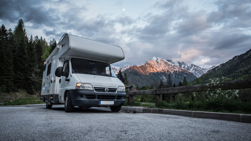 RV on the road by mountains